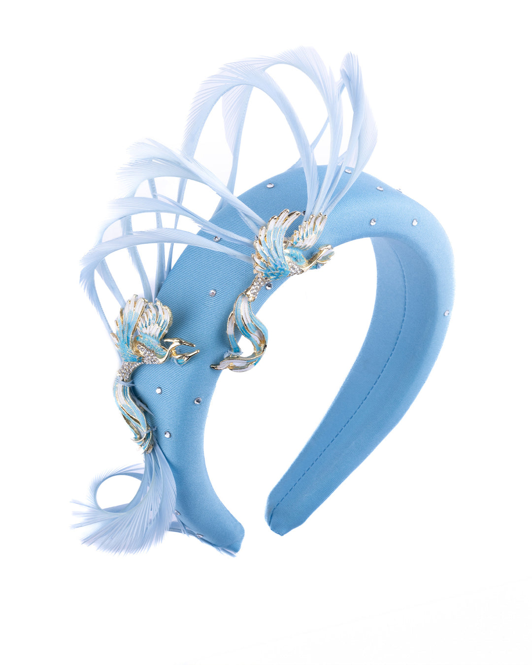 Aqua blue padded headband embellished with crystal accents, featuring gold and blue bird appliqués with flowing feather details for a bold, statement finish. Designed and made by Merve Bayindir Millinery.
