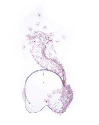A delicate pink floral sheer mask adorned with tiny flower appliqués with pink crystals extends from the upper face, cascading upwards and blending seamlessly into a whimsical, semi-transparent veil that gives an ethereal and artistic touch. The mask covers the eye part of the face.