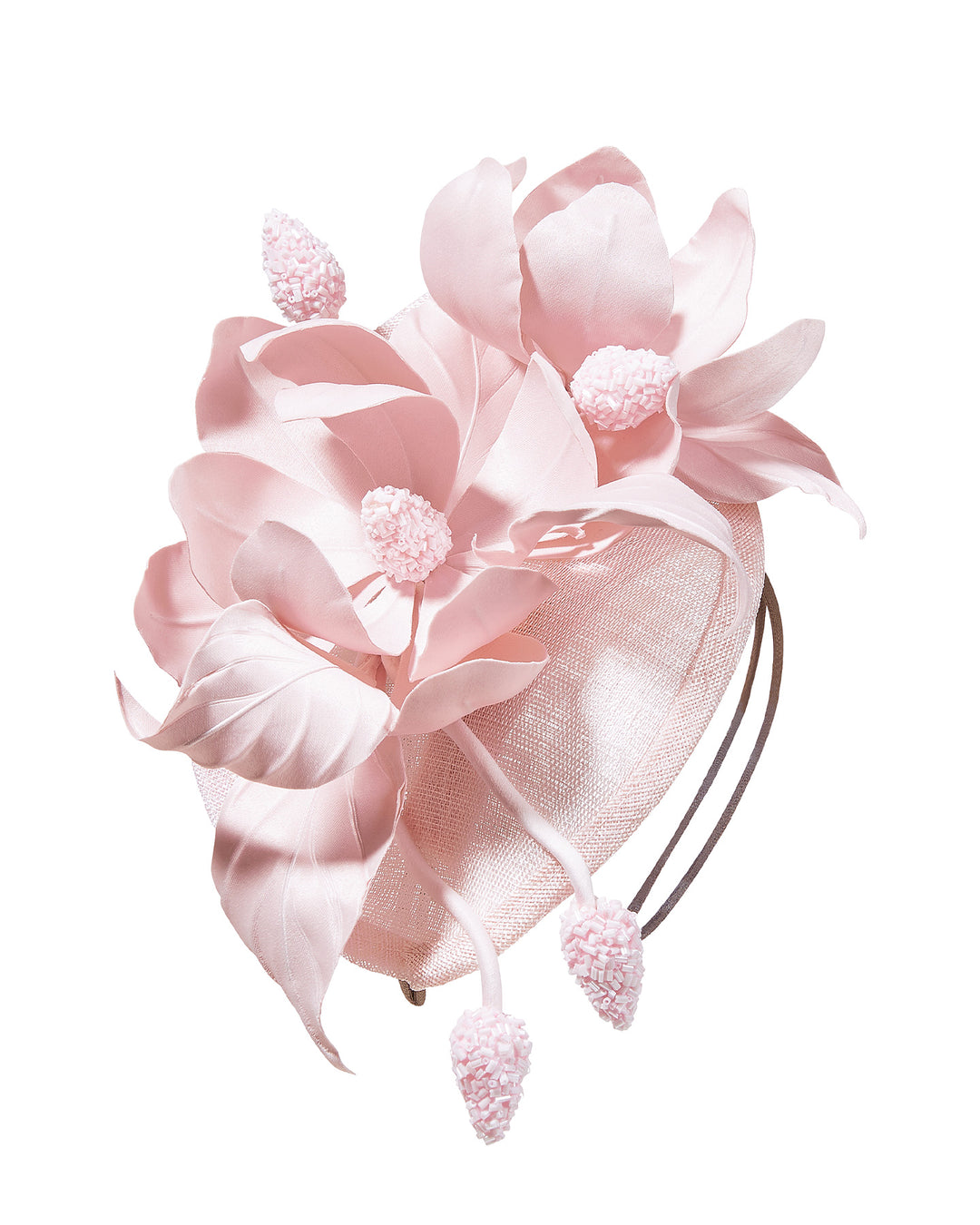 Blush pink sinamay fascinator adorned with oversized handcrafted satin flowers, beaded centers, sculpted leaves, and curved stem details, mounted on a slim headband. Designed and made by Merve Bayindir Millinery.
