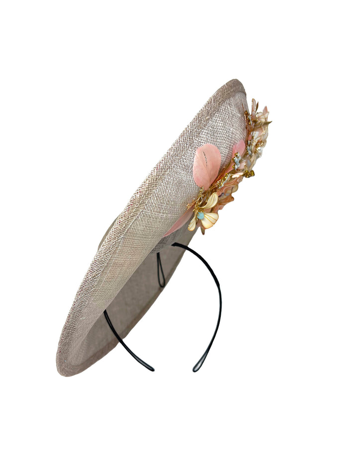 Decorative hat with floral embellishments on a white background