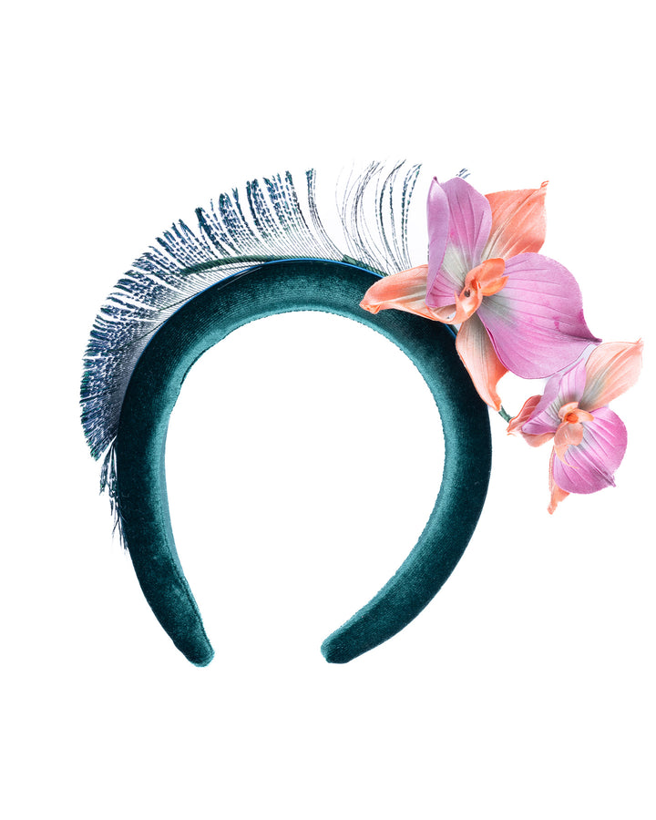 Emerald green velvet padded headband embellished with pink and peach orchid flowers and a delicate fan of dark green feather trim along one side. Designed and made by Merve Bayindir Millinery.
