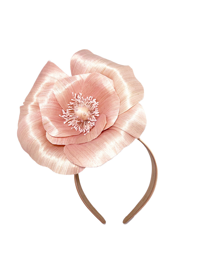 Pink flower headband on a white background