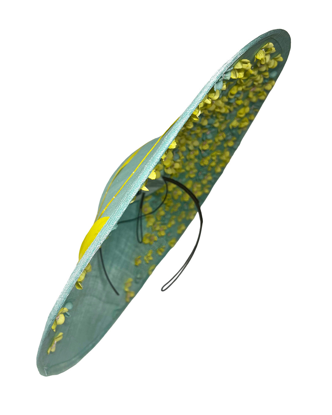 Mint coloured sinamay base hat with a wide sculpted brim, featuring delicate yellow flowers lining the underside and finished with a bold yellow feather accent on the outer edge for a striking contrast. Designed and made by Merve Bayindir Millinery.
