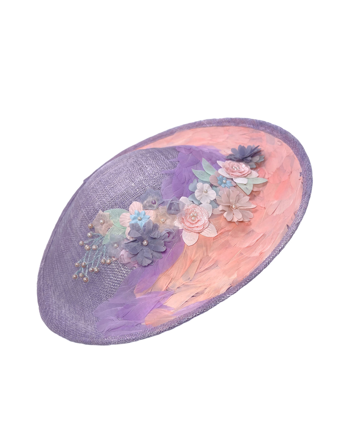 Decorative hat with floral embellishments on a white background