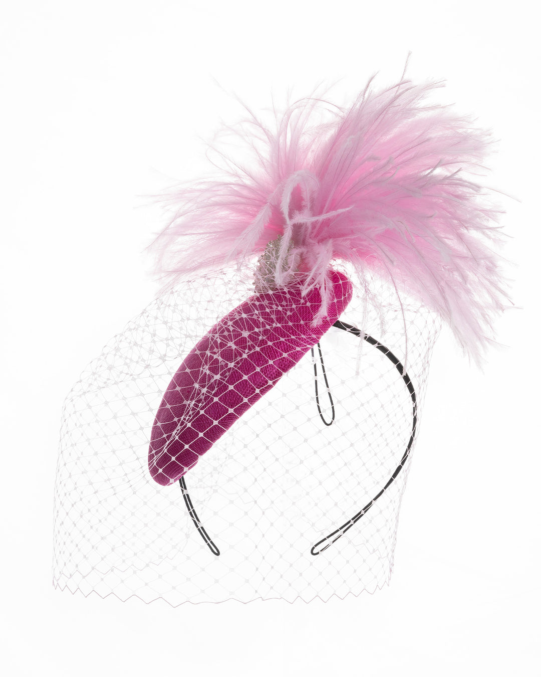 Fuchsia velvet padded headband with a pink feather pom-pom detail, finished with a soft birdcage veil overlay and mounted on a slim black headband. Designed and made by Merve Bayindir Millinery.

