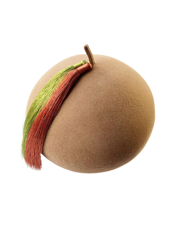 Still life picture of the Faye Beret Hat, handcrafted in camel wool felt. It&