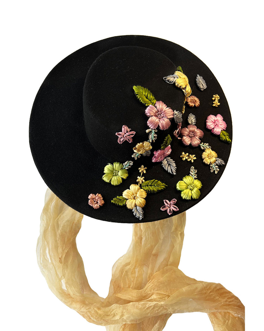 The still life image of the wool felt wide-brimmed boater hat. The right side of the hat which has multi-colour satin embroidery flower details, as well as the long of an organza long scarf that falls from both sides. Designed by Merve Bayindir.
