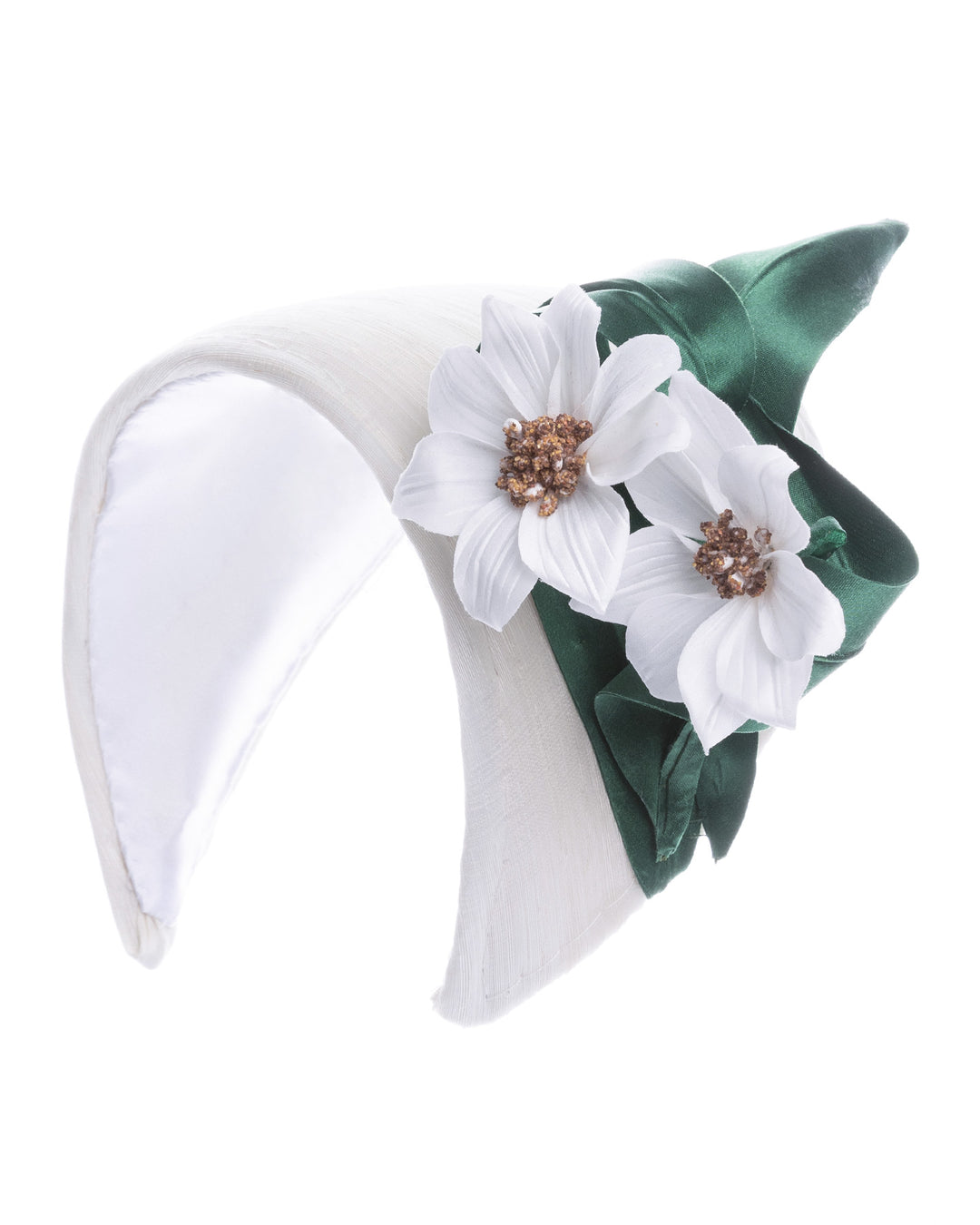 Structured white half-hat in smooth fabric, adorned with two white floral appliqués featuring gold beaded centers and finished with sculpted deep green leaves for contrast. Designed and made by Merve Bayindir Millinery.
