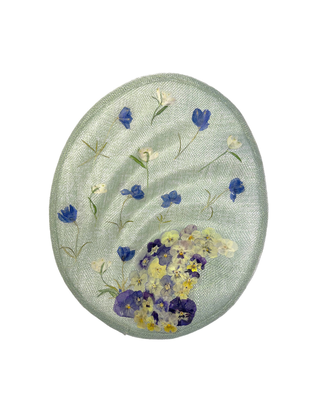 Round embroidered patch with floral design on a light green background