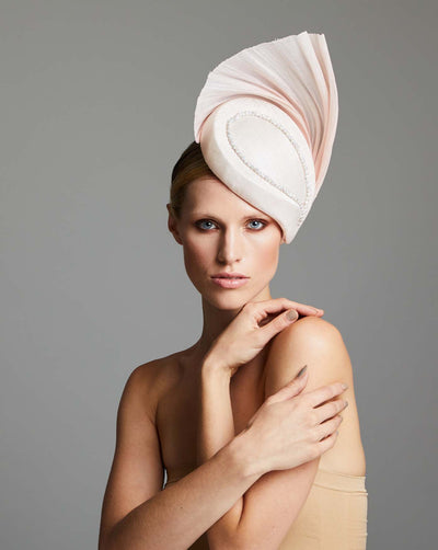 Side drop pink preacher hat decorated with a pink silk abaca fan and embroidered with rhinestones.