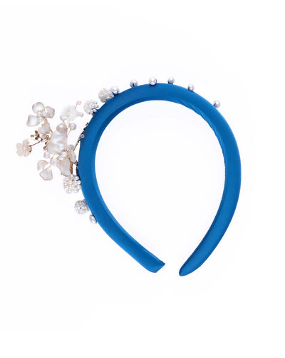 A teal silk sateen headband, a favourite yet hard to find colour decorated with mother of pearl wired flowers as well as mother pearl balls and beads. The pearl on the headband elevates the idea of a simple headband to a whole new level.