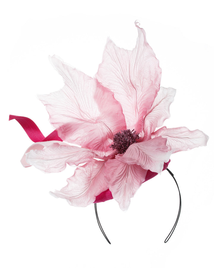 Button shape Sinamay base decorated with custom made large silk chiffon flower and Jinsin swirls. Fitted with a wire headband and comb. Designed and made by Merve Bayindir Millinery.
