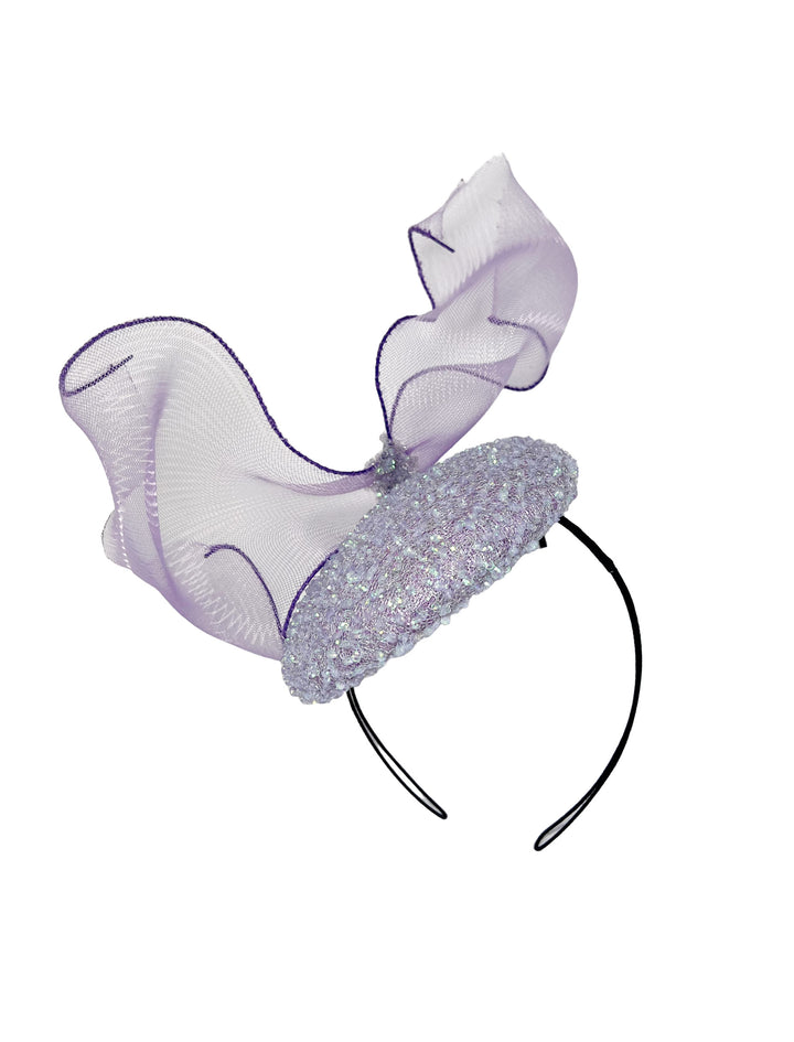 Decorative headband with a bow and glittery base on a white background
