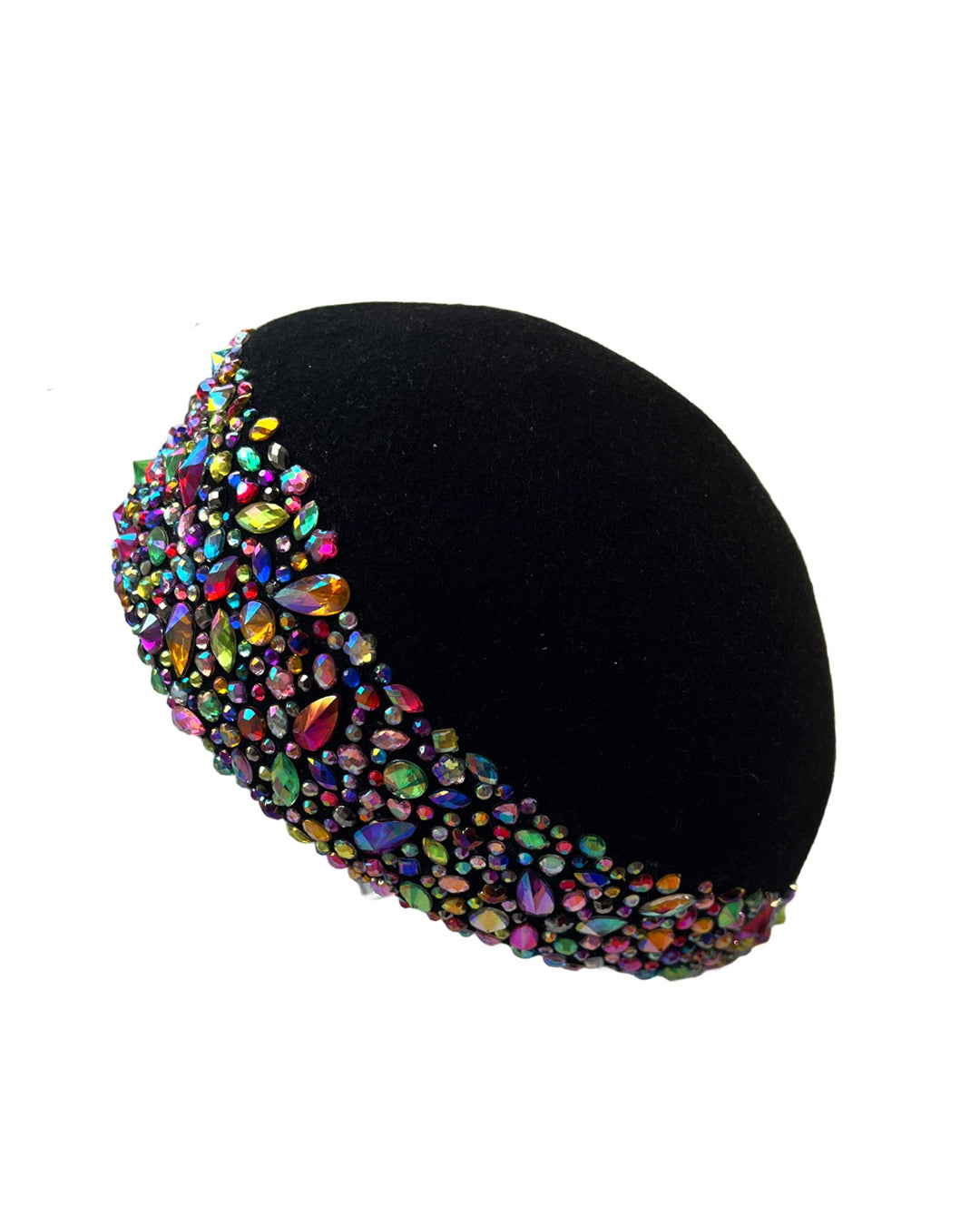 Still life picture of the Lumi Beret, crafted in classic black felt, and adorned with multi-coloured crystals that wrap across the front to the side of the brim. Designed by Merve Bayindir.