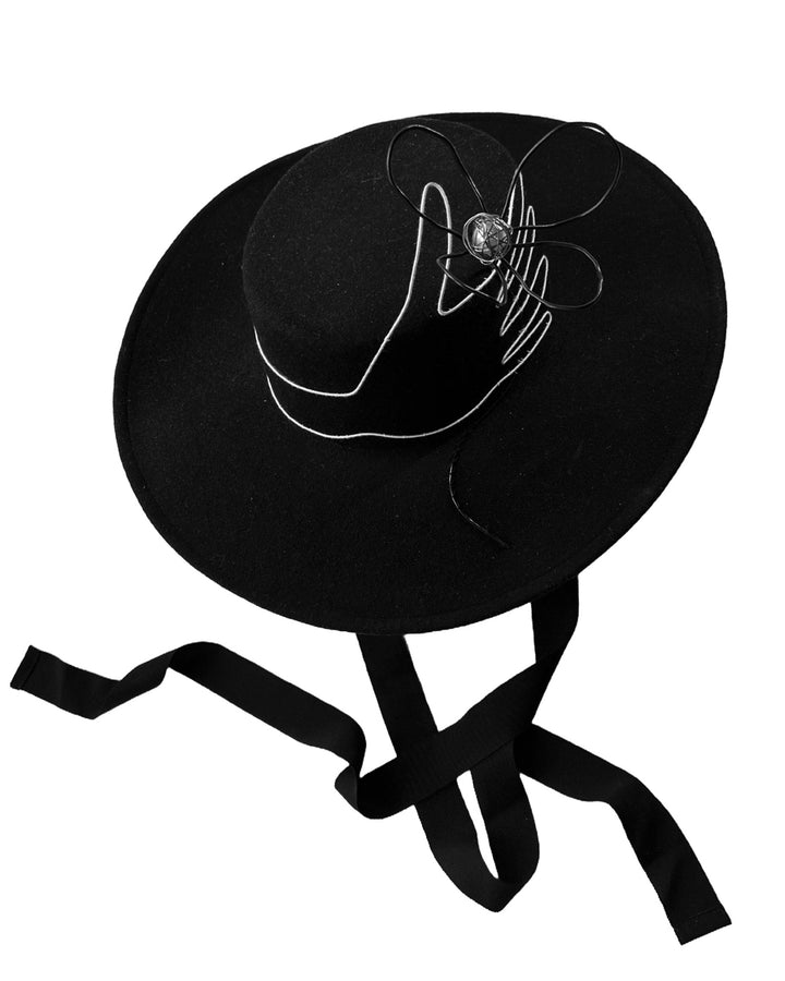 Still life picture of the Lune wide-brim boater hat, crafted in deep black felt, the hat&