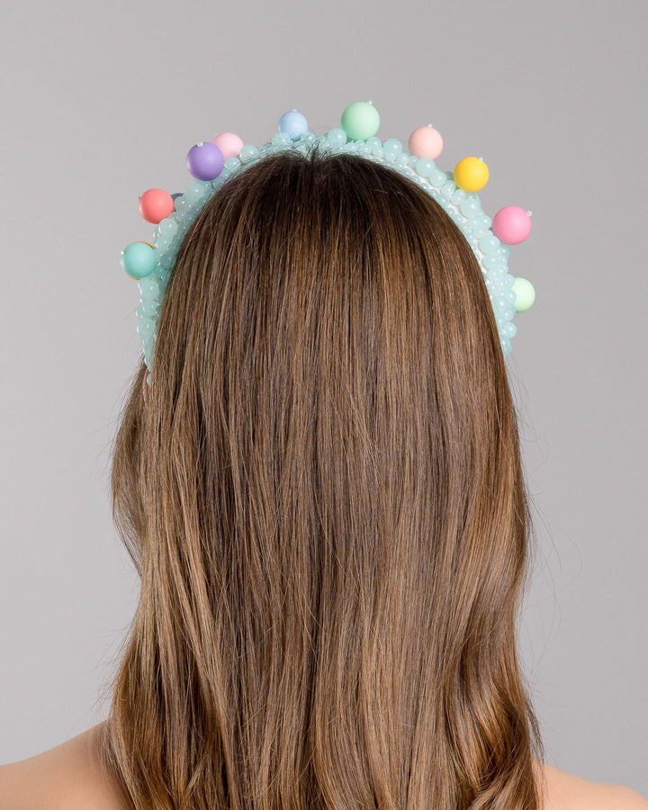 Model is showcasing the back side close up of multi size mint coloured beaded headband adorned with large multi size mat bubble look a like multi colour multi size beads. Made by Merve Bayindir.