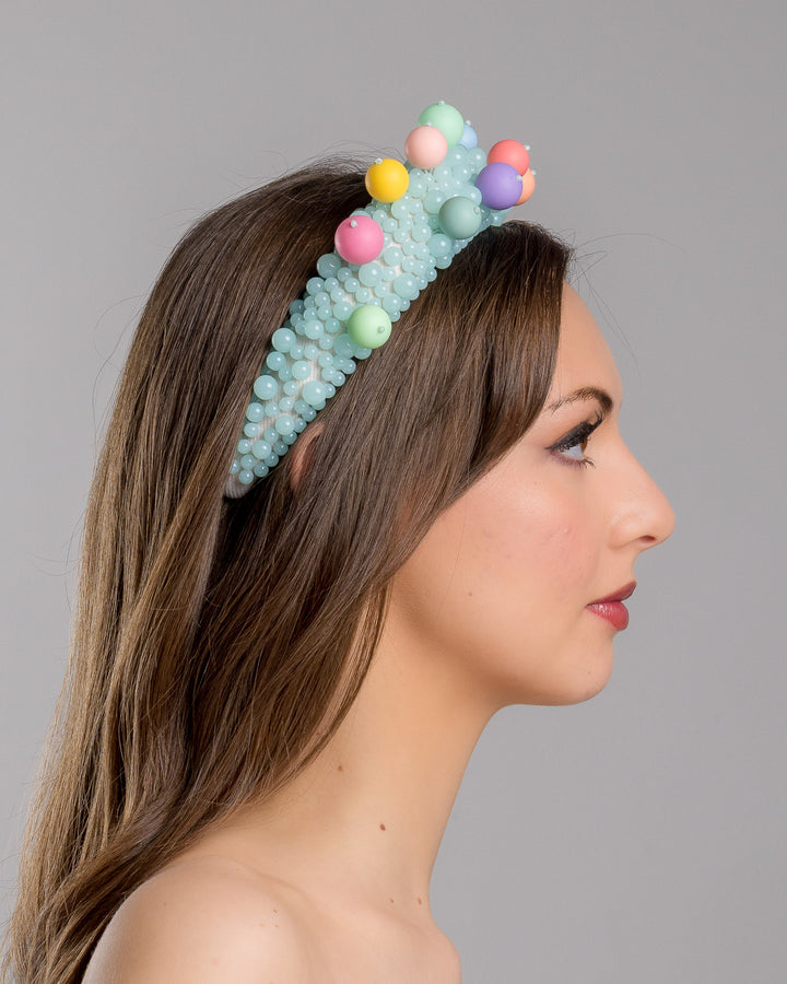 Model is showcasing the right side close up of multi size mint coloured beaded headband adorned with large multi size mat bubble look a like multi colour multi size beads. Made by Merve Bayindir.