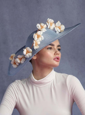 Blue wide shaped millinery decorated with flowers