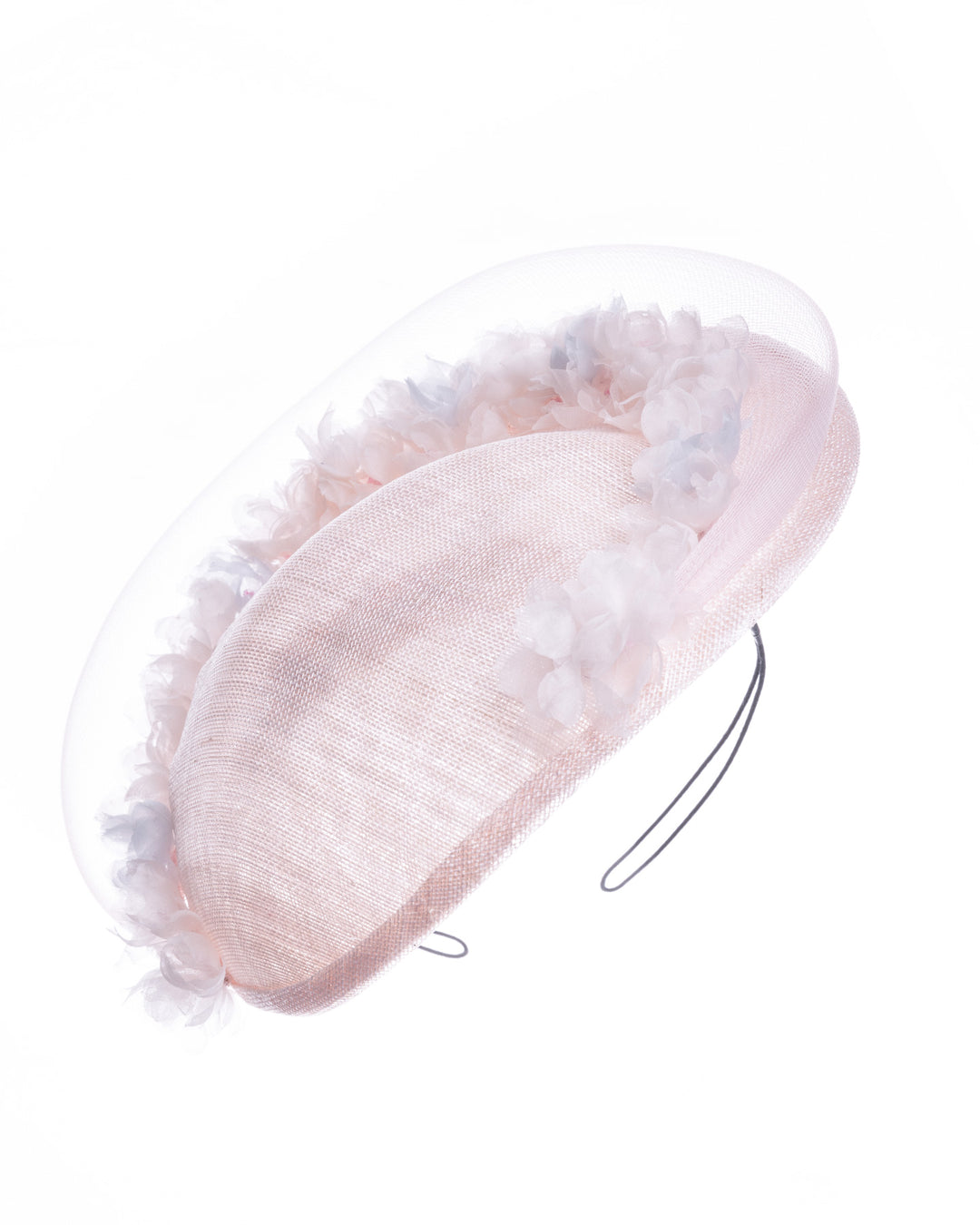 Blush pink sinamay fascinator with a soft oval crown, trimmed with delicate pastel chiffon flowers and finished with a sheer pale veil overlay, mounted on a slim black headband. Designed and made by Merve Bayindir Millinery.

