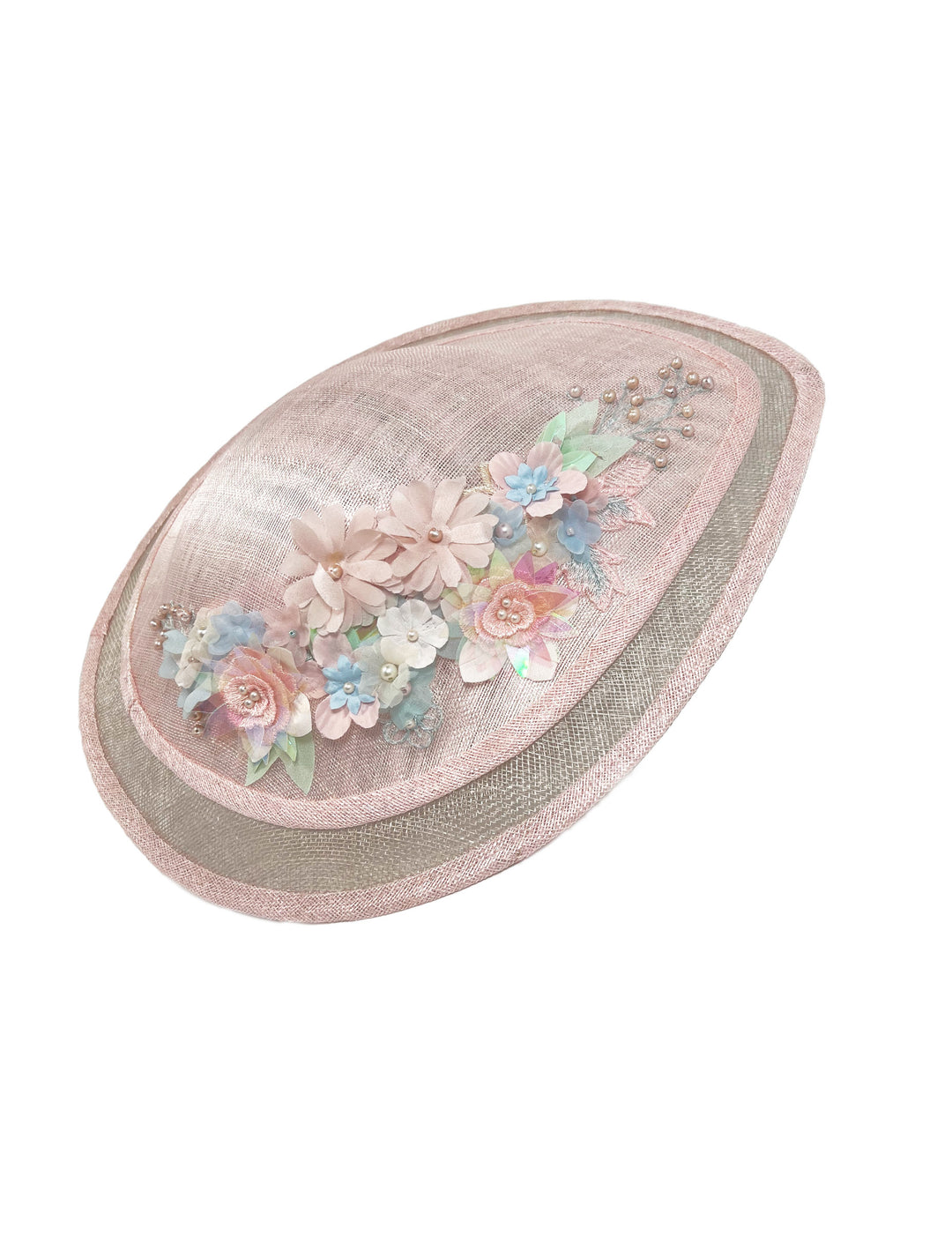 Decorative hat with floral embellishments on a white background