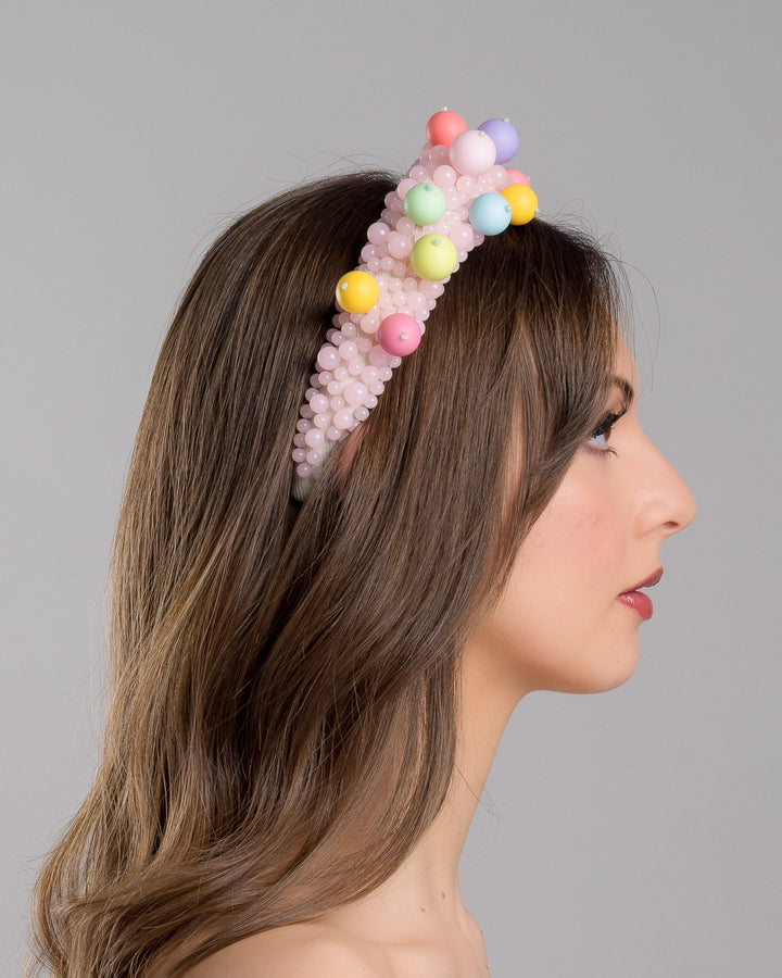 Strawberry Headband Model is showcasing right side close up multi size pink beaded headband adorned with large multi size mat bubble look a like multi colour multi size beads. Mde by Merve Bayindir.
