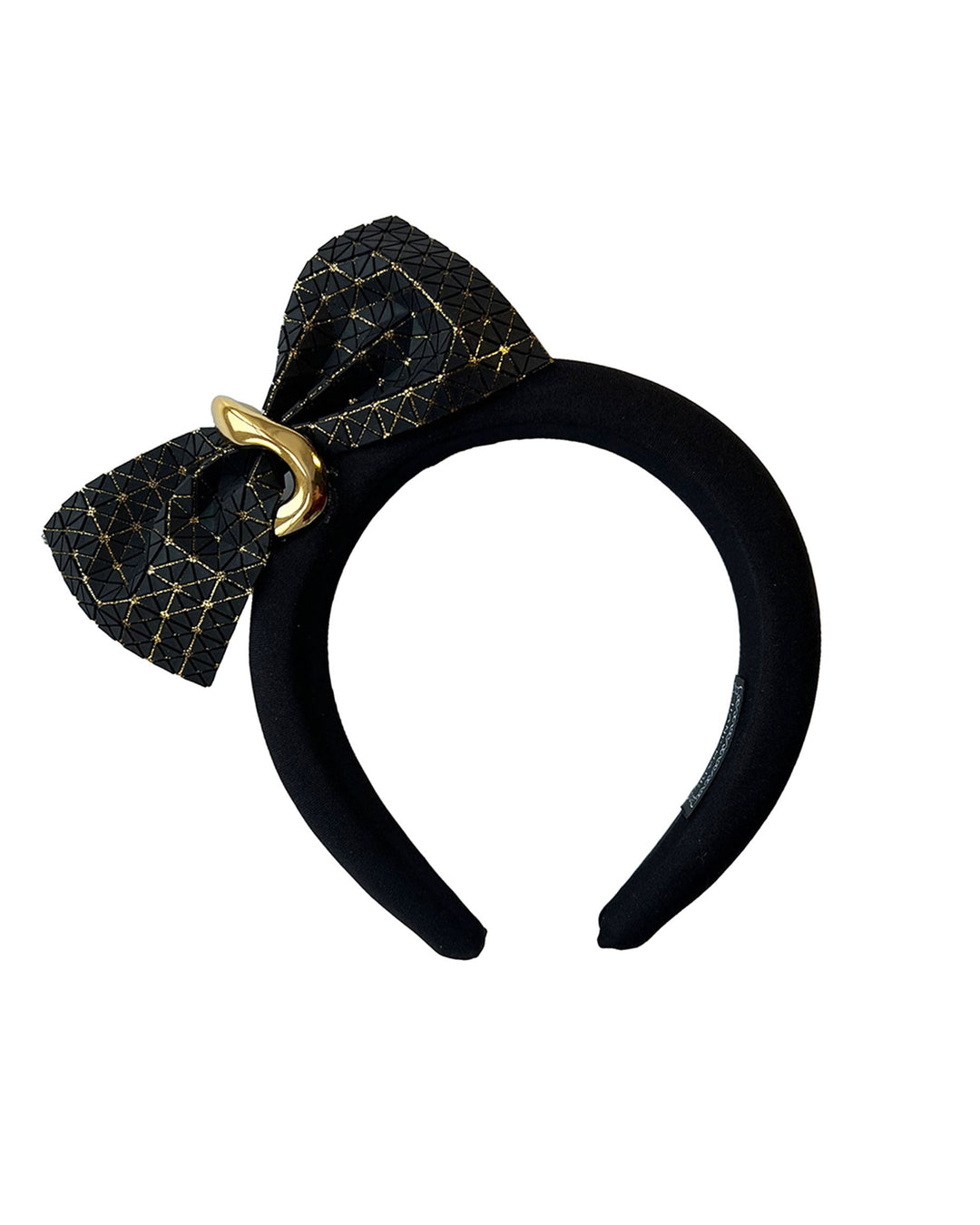 Still life picture of the Valkyrie, which features a sculpted bow headband with a gold ring detail. This holds a structured bow in black faux leather with a gold metallic base. The bow is dramatically placed across a plush headband base cinched by the gold-tone ring. Designed by Merve Bayindir.