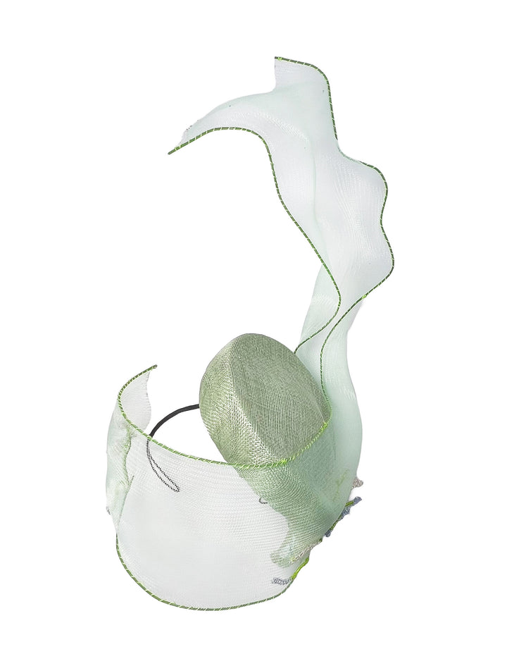 Decorative headpiece with white and green feathers on a white background