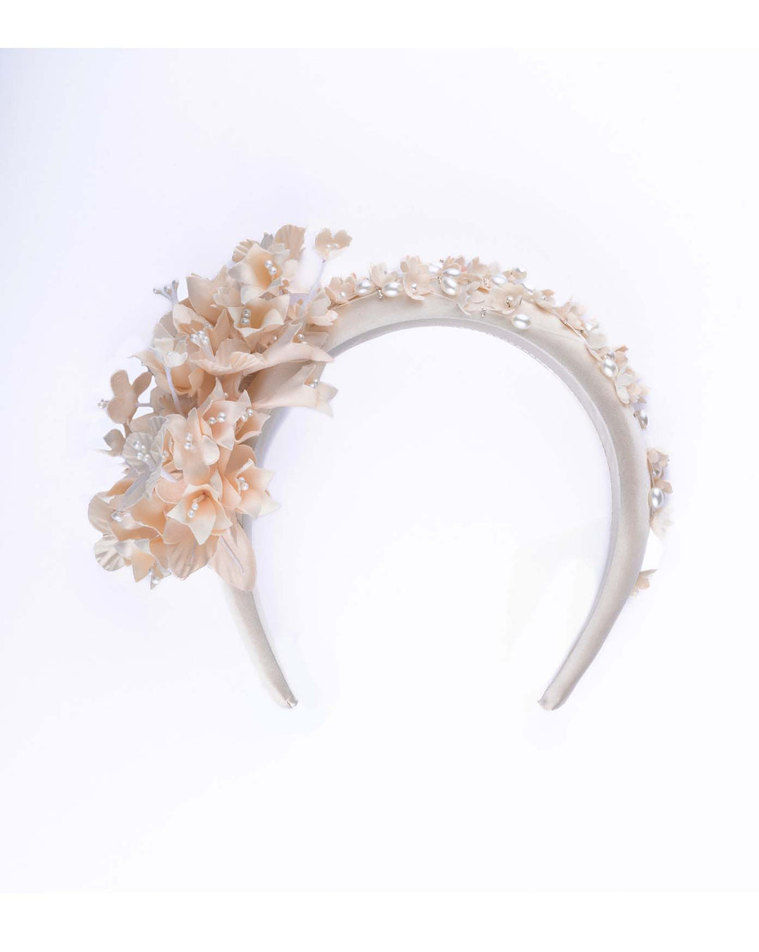 Still life picture of Beige coloured silk sateen ivory headband decorated with ivory cotton flowers an ivory beads. Made by Merve Bayindir.