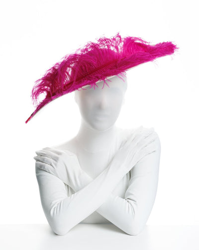 Light pink asymmetric wide brim hat decorated with hot pint ostrich feather.