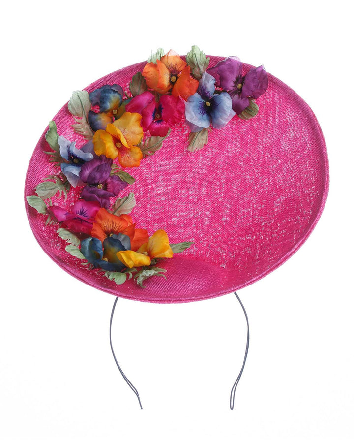  large size oval shaped hot pink fascinator decorated with custom made silk organza multi-coloured violets. Designed and made by Merve Bayindir Millinery.

