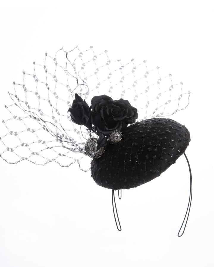 Medium sateen button shaped fascinator covered with laced tulle with sparkles. The button fascinator is sateen roses, large pearl coloured beads and veil tulle in the back.