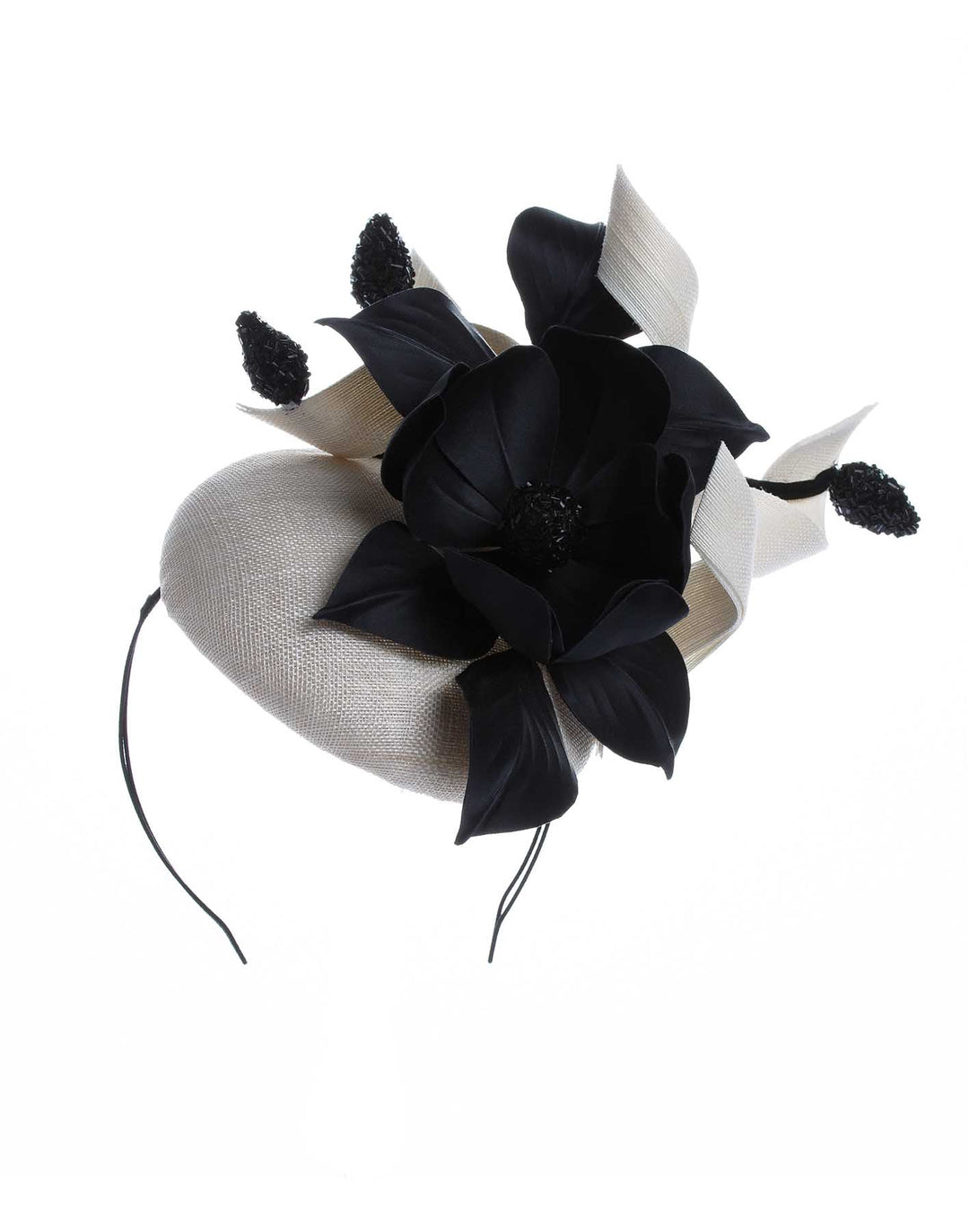 A grade sinamay button shaped white fascinator decorated with white Jinsin Swirls and custom made black American Sateen Cala flower. Designed and made by Merve Bayindir Millinery.
