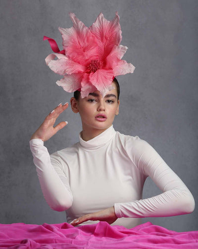 Model is showcasing the large flower on button shape hot pink fascinator. The custom made extra large silk chiffon and Jinsin swirls.