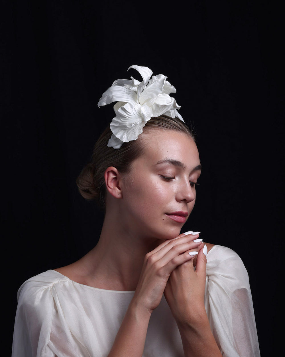 Model is showcasing a flower on a Sateen bridal headband.