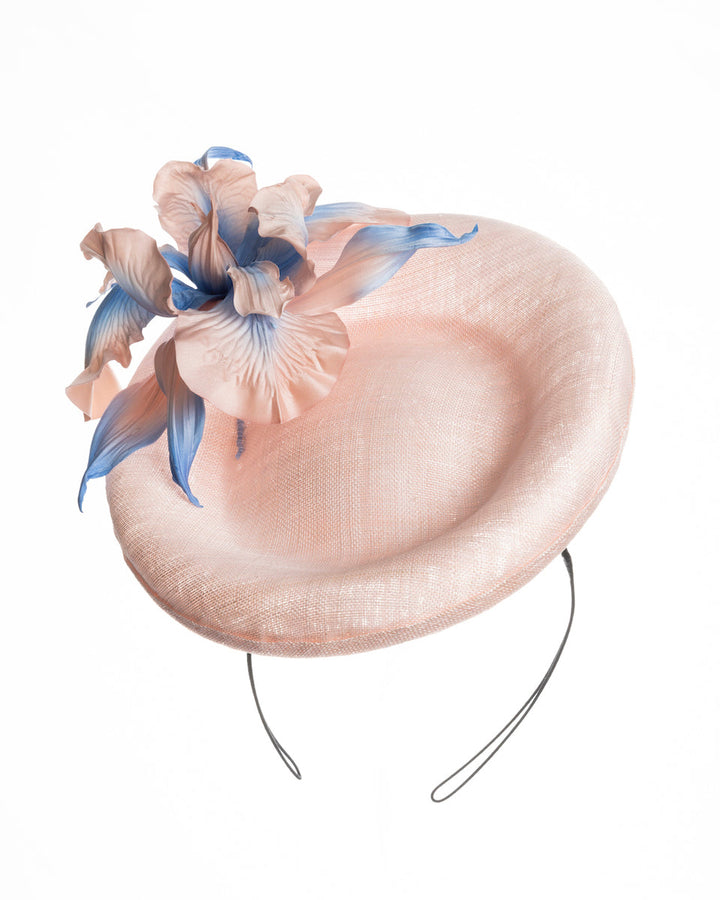Light pink oval high based fascinator decorated with custom made pink and blue shaded flowers. Designed and made by Merve Bayindir Millinery.
