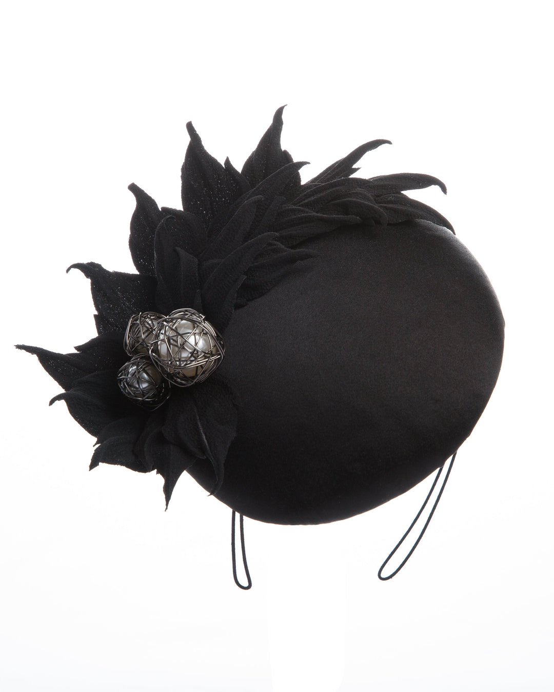 The button style sateen based fascinator decorated with crepe leafs and centred with wire embellished plastic large pearls.