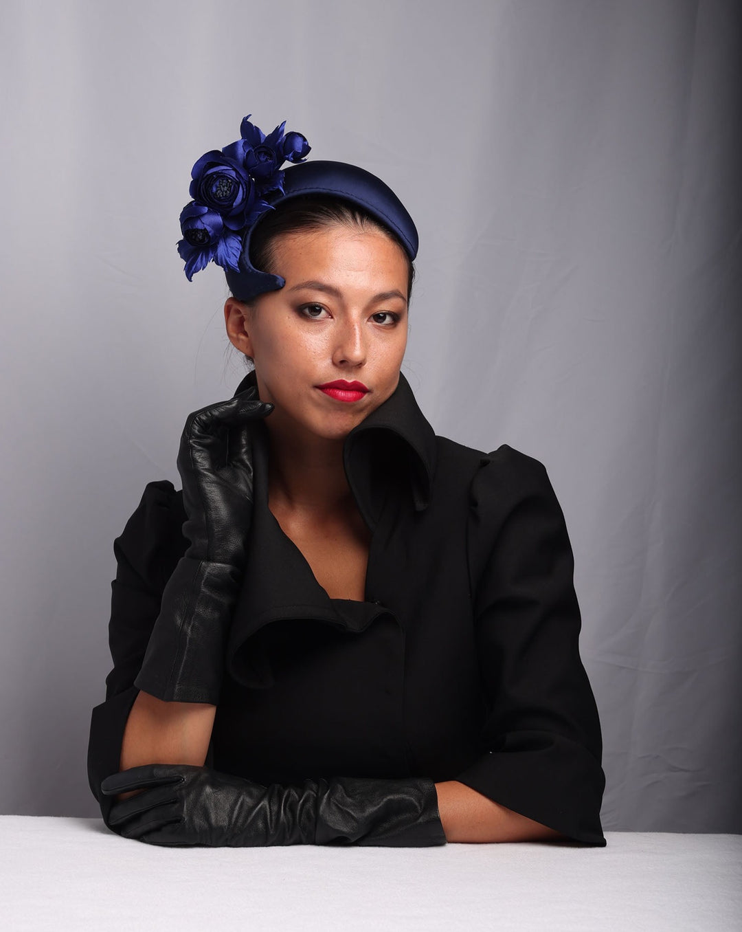 model is showcasing the right curvy side of Signature "S" shaped navy sateen headband decorated with wild rose bouquet on the right side.