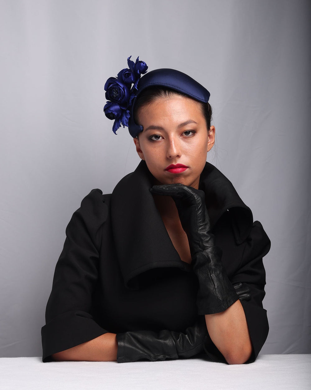 model is showcasing Signature "S" shaped navy sateen headband decorated with wild rose bouquet on the right side.