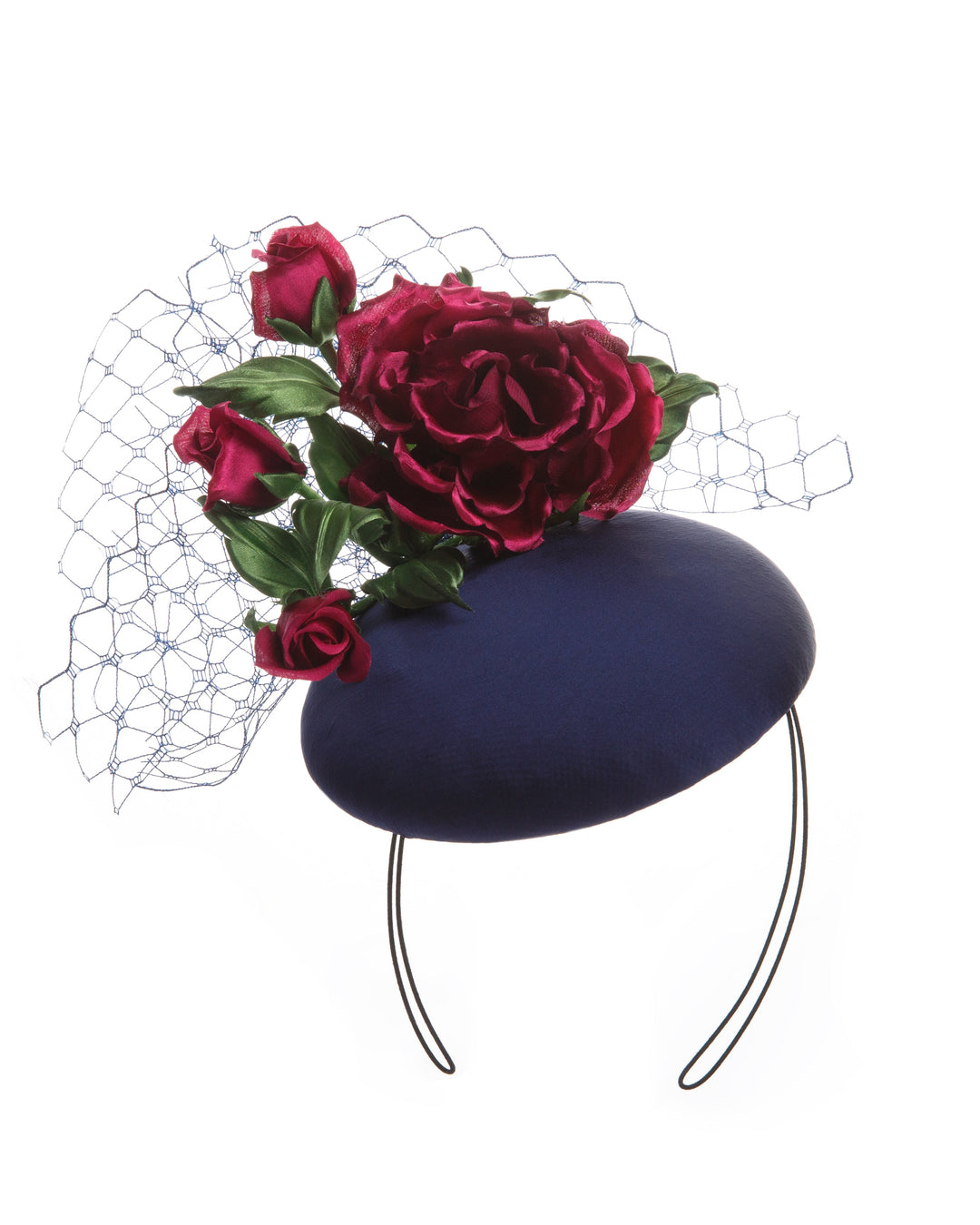 Sateen button shaped fascinator, decorated with dark pink sateen roses embellished with green leaves and navy veil.